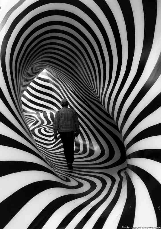 Man walking through the swirly tunnel